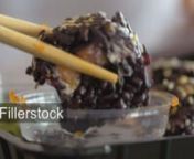Closeup shot of a smartphone in someone&#39;s hand. Then focus racking to the Japanese food taken with chopsticks and dipping into soy sauce.nLicense this clip: https://fillerstock.com/video/5738
