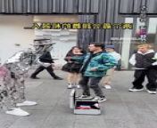 A robot dancing with a guy on the road