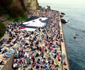 Hundreds of people lie on the ground by the sea in the Basque city of San Sebastian, Spain, during a pro-Palestinian protest asking to &#92;