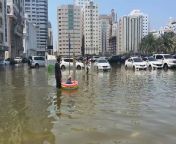 Sharjah residents use inflatables to wade through the water from using c