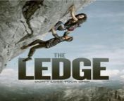 A climber trapped on the face of a mountain fights off four killers stood on an overhanging ledge twenty feet above her.