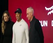 Tiger Woods wears Sun Day Red apparel.