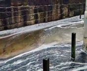 Waves crashing over the sea wall at Anstruther