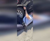 This is the heartwarming moment a policeman saved a kitten trapped behind a car wheel in Brooklyn, New York, on May 2.The officer in his NYPD shirt lay on the ground extended his arm under the vehicle, reaching behind the wheel to retrieve the small black-and-white kitten. Witnessing the rescue unfold, a woman&#039;s voice exclaims, &#92;